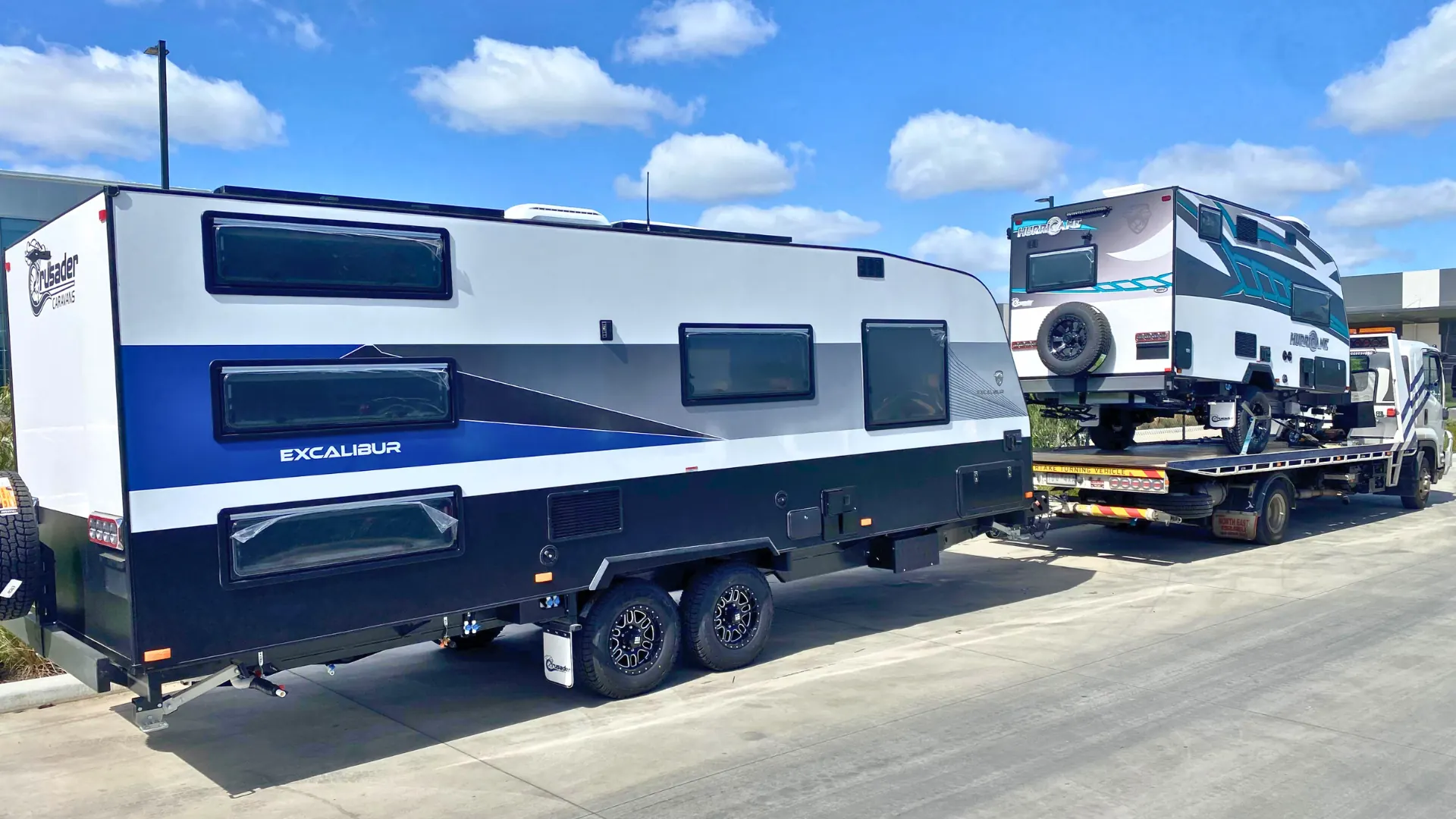 White Excalibur caravan secured on the All Over Towing tilt tray