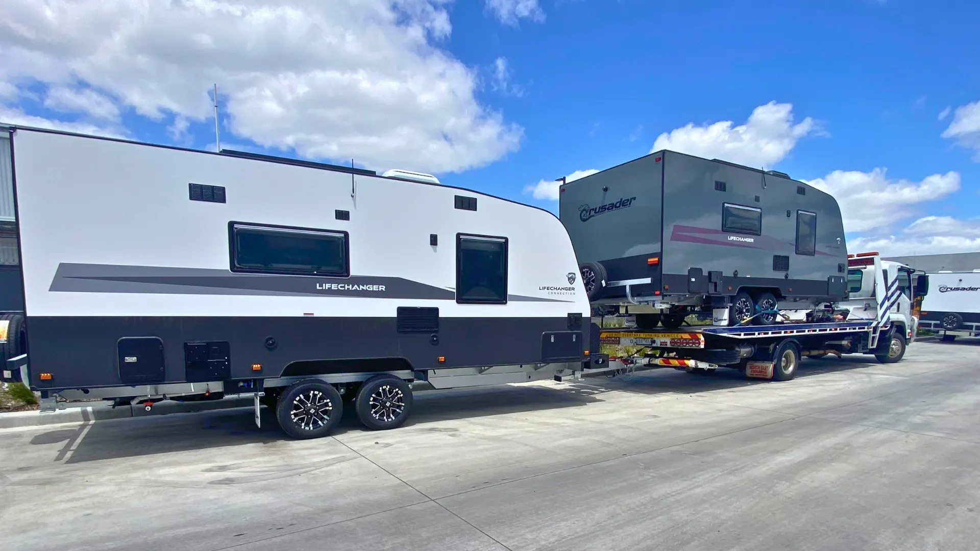 Caravan secured on the All Over Towing tilt tray for a long-distance transport job