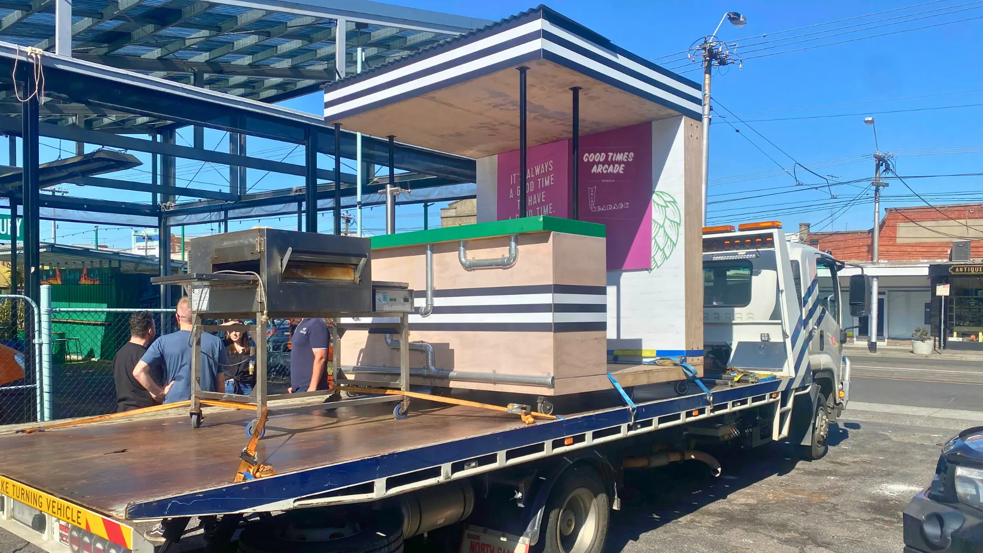 Large fabricated retail structure loaded on the All Over Towing tray at a shopping centre